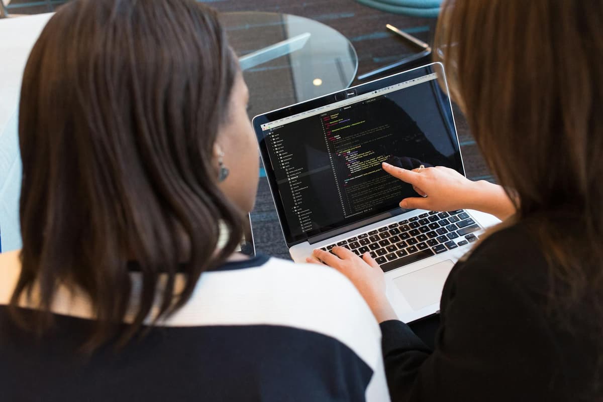 Modern technology workspace with developers and screens — information and communication sector
